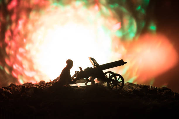 istock Man with Machine gun at night, fire explosion background or Military silhouettes fighting scene on war fog sky background, World War Soldiers Silhouettes Below Cloudy Skyline At night. 917923592
