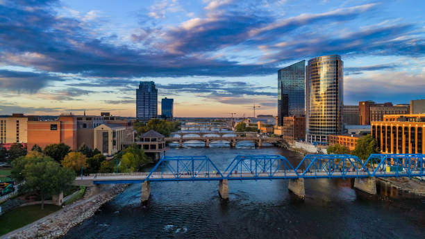 Grand Rapids Aerial at Sunset with River and Bridges Downtown Grand Rapids aerial with Grand River and bridges during sunset, with a beautiful cloudscape in the background, and the Blue Bridge pedestrian bridge in the foreground. michigan photos stock pictures, royalty-free photos & images