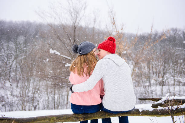 Happy couple at snow background from back