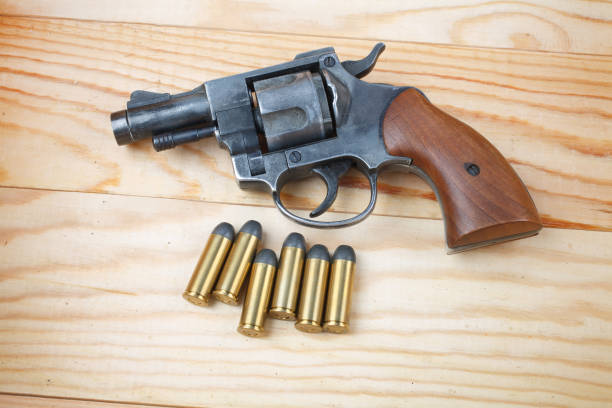 istock Revolver with ammunition on the wooden table 917926278