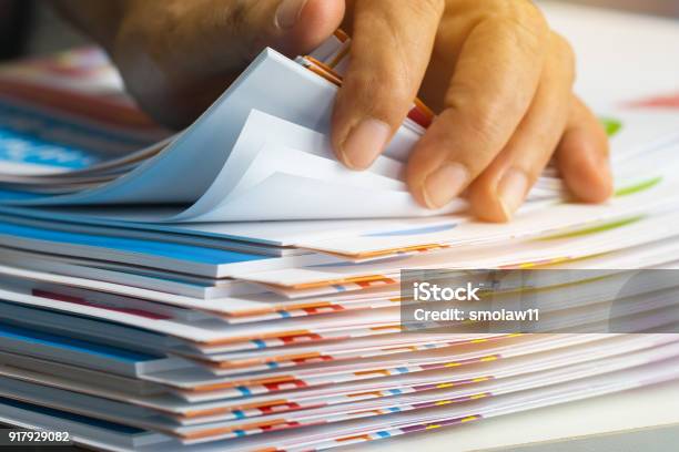 Businessman Hands Searching Unfinished Documents Stacks Of Paper Files On Office Desk For Report Papers Piles Of Sheet Achieves With Clips On Table Document Is Written Drawnpresented Stock Photo - Download Image Now