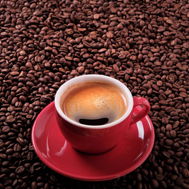 istock Red coffee cup espresso roasted beans background 917930340