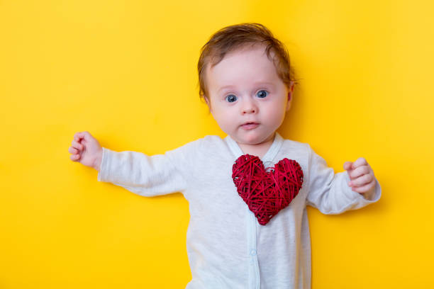istock little baby with red heart shape toy 917937752