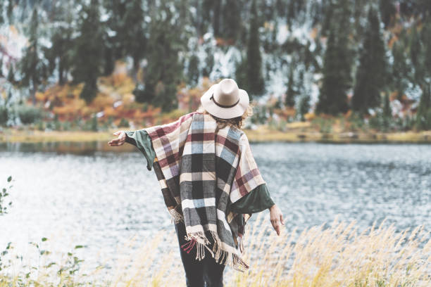 istock Woman traveling among mountains wilderness, boho style 917938012