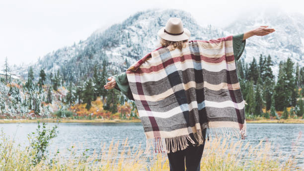 istock Woman traveling among mountains wilderness, boho style 917940504