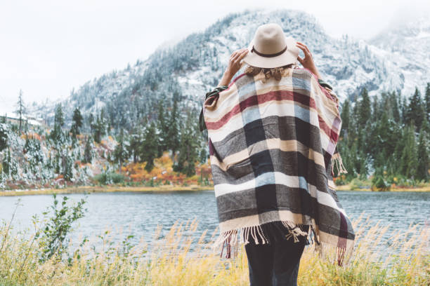 istock Woman traveling among mountains wilderness, boho style 917940598