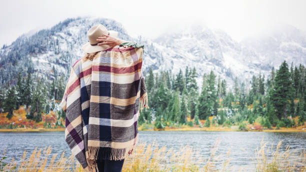 istock Woman traveling among mountains wilderness, boho style 917940758