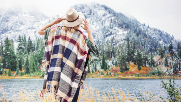 istock Woman traveling among mountains wilderness, boho style 917940826