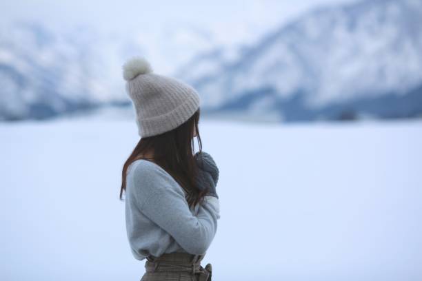 istock Young Woman watching something at snow field 917941004