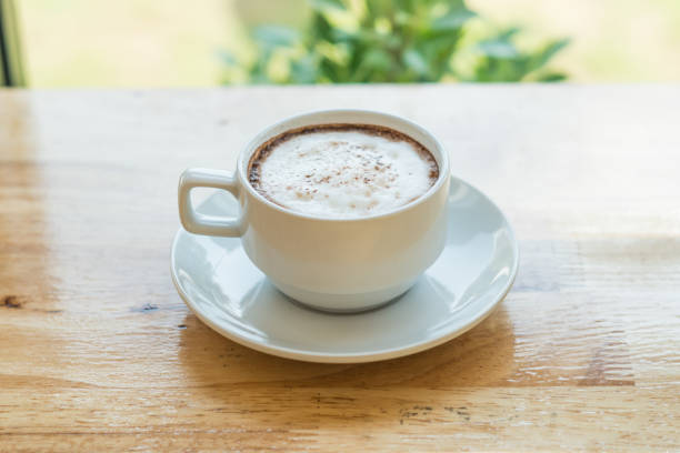 istock hot coffee in white cup on wood in coffee shop 917941008