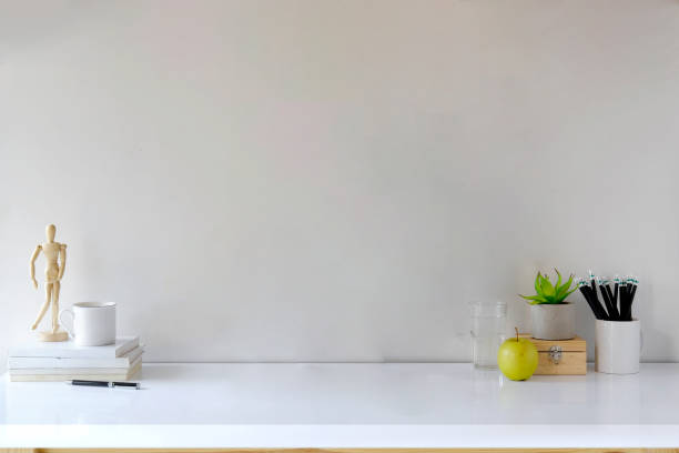 istock Comfortable workspace desk with books, house plant, pencils and coffee mug with copy space 917941292