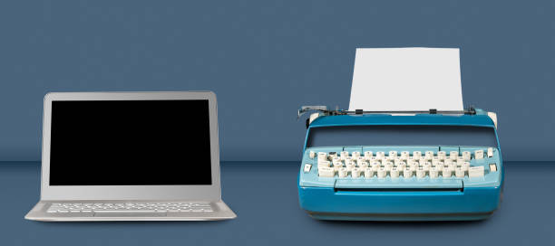 istock Old electric typewriter with laptop on blue table background 917944104