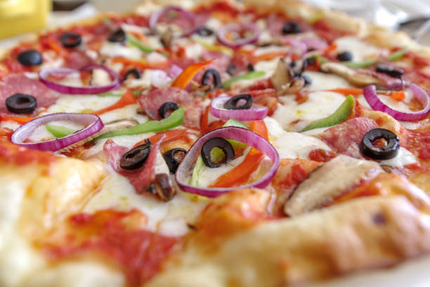 istock Italian style thin pizza on the table 917944194