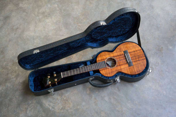 istock curly koa ukulele gloss finished and hard case on concrete floor background 917944620
