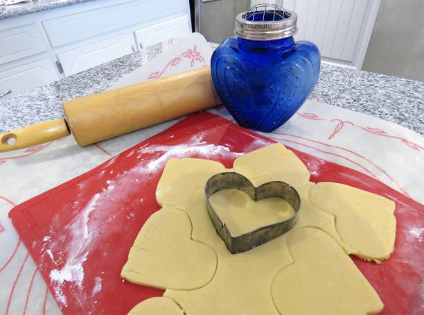 istock heart-shaped cookie cutter cutting dough 917945182