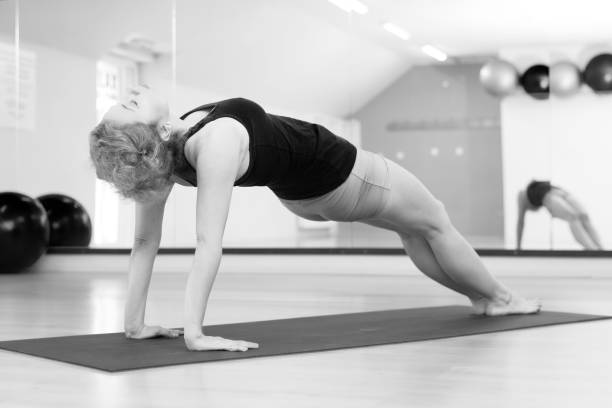 istock Middle aged woman doing yoga 917947248