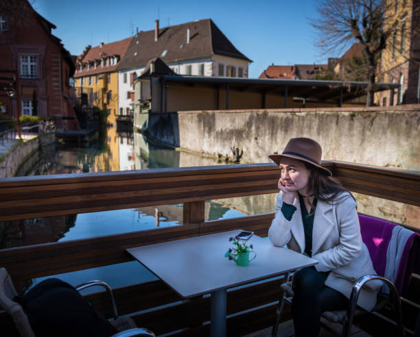 istock Young pensive woman sits at the table in cafe 917947824