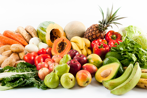 Large fruits and vegetables composition on white background. Healthy food. Vegetarian or vegan. Natural and organic fruit and vegetables. No people. Studio photography. Still life. Front view. Horizontal orientation.