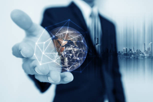 istock Businessman holding globe hologram with network connection lines. Global business networking, currency exchange and travel around the world concept. Element of this image are furnished by NASA 917954376