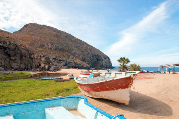 Small fishing boat / ponga at Punta Lobos beach on the coast of Baja California Mexico BCS Small fishing boat / ponga at Punta Lobos beach on the coast of Baja California Mexico BCS baja california peninsula stock pictures, royalty-free photos & images