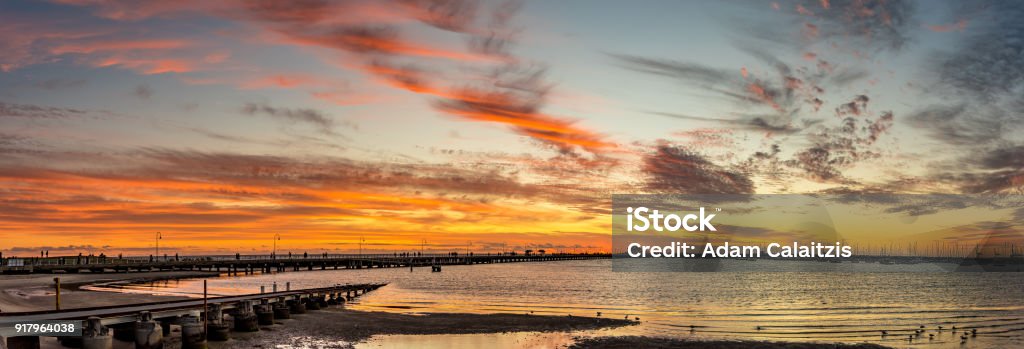 St Kilda Peir An early evening view of the St Kilda pier against a dramatic red sunset in Melbourne, Victoria, Australia Architecture Stock Photo