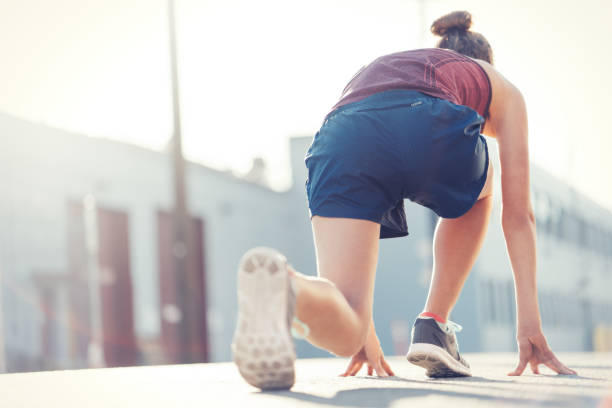 istock Woman preparing for start, low running position 917974380