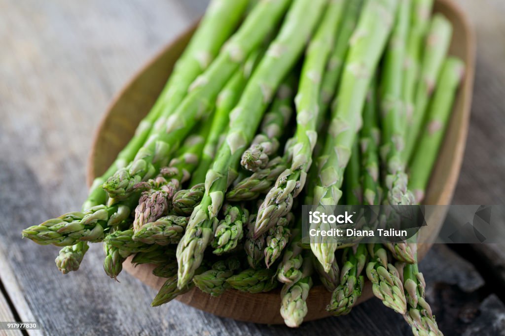 asparagus on wooden surface Asparagus Stock Photo