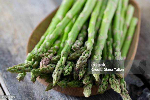 Asparagus On Wooden Surface Stock Photo - Download Image Now - Asparagus, Vegetable, Green Color