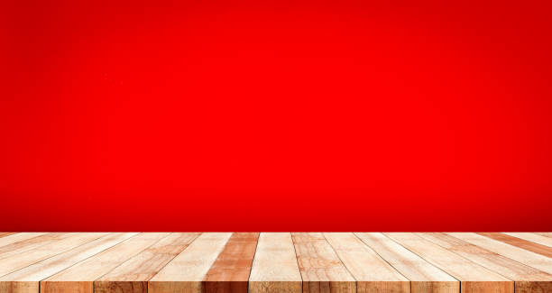 istock wooden table top with color red background 917983926