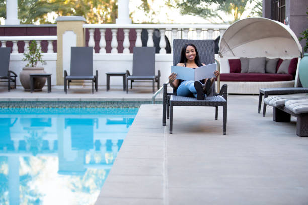 istock Single Woman Looking at Hotel or Spa Brochure 917987234