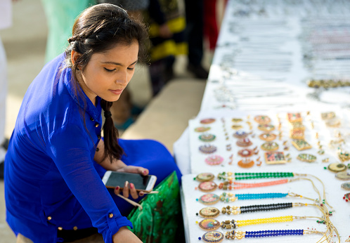 Woman shopping for jewelry at Surajkund Crafts Fair