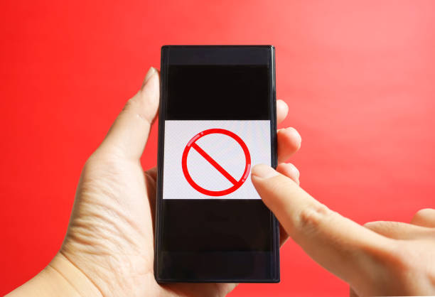 istock The smartphone which is operated. danger site, cation, prohibited from reading, etc. red background 917987534