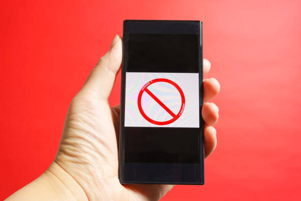 istock The smartphone which is operated. danger site, cation, prohibited from reading, etc. red background 917987540