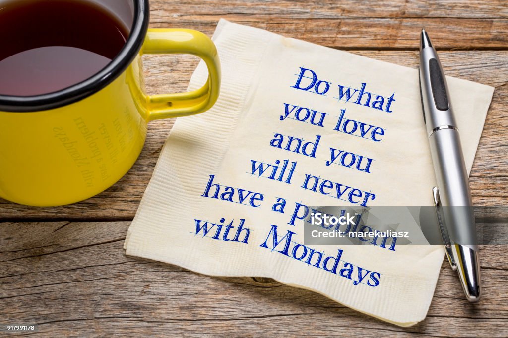 Do what you love and ... napkin note Do what you love and you will never have a problem with Mondays - handwriting on napkin with a cup of tea Monday Stock Photo