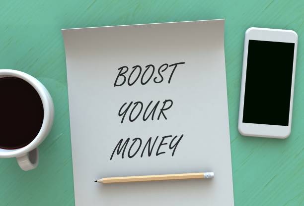 istock BOOST YOUR MONEY, message on paper, smart phone and coffee on table, 3D rendering 917991256