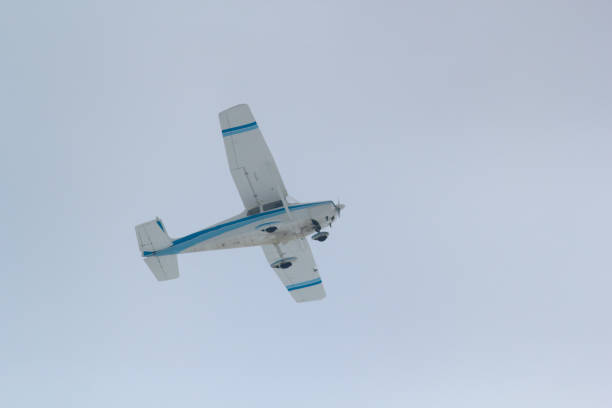 istock Small sports plane flying in the cloudy sky 917991724