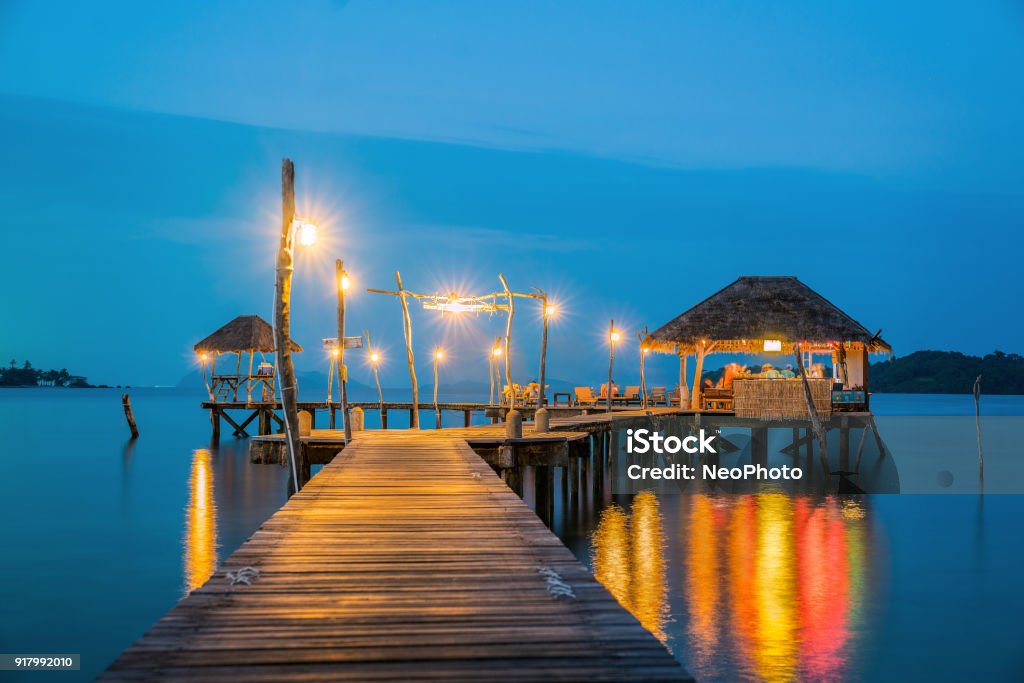 Wooded bridge to Koh Mak harbor after sunset Wooded bridge to Koh Mak harbor after sunset, Koh Mak and Koh Kood is island in Thailand, This photo can use for Relax, Holiday, Asia, travel, Beach and Summer concept Night Stock Photo