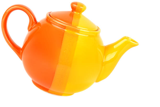 istock Orange color porcelain teapot, isolated on white background 917995538