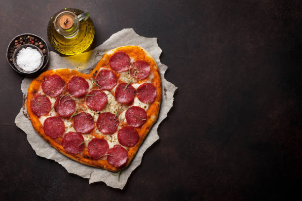 istock Heart shaped pizza with pepperoni 917999792
