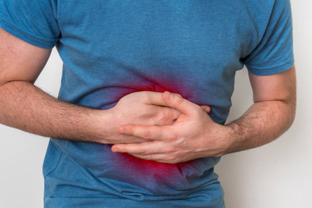 istock Man with stomach pain is holding his aching belly 918003946