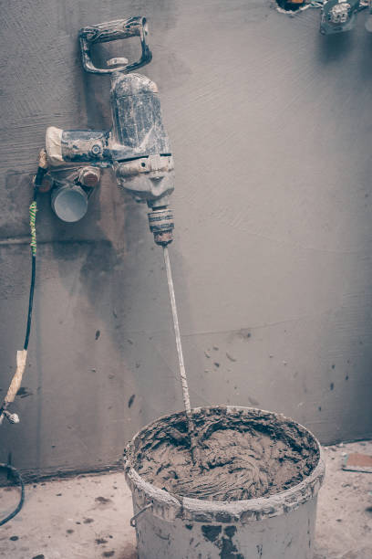 istock Mixer in a bucket with ready-made tile adhesive, construction tools for finishing works 918006320
