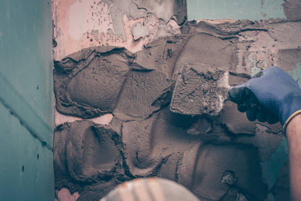 istock The worker applies the plaster to the wall for leveling, based on the tile work 918007508