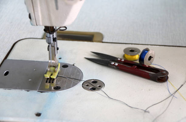 istock Sewing machine and sewing accessories, scissors Clippers with blue and yellow thread in the bobbins. 918008034