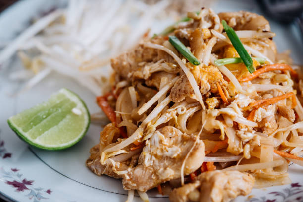 Pad Thai meal served with chicken or prawns Enjoying local food in Thailand. Street food is part of local folklore PAD THAI stock pictures, royalty-free photos & images