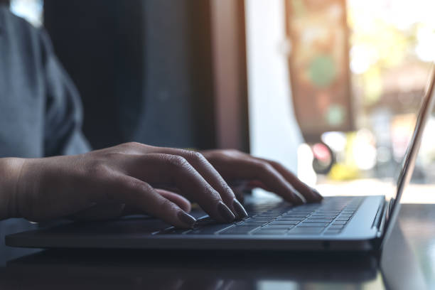 istock a business woman's hands working and typing on laptop keyboard 918011628