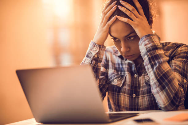 istock African American woman reading a problematic e-mail on laptop. 918011646