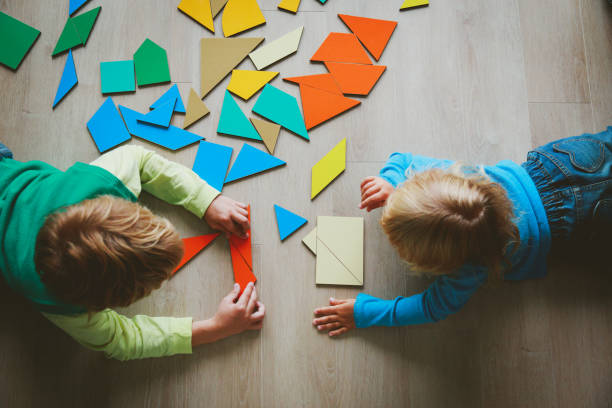 istock kids playing with puzzle, learn shapes, education concept 918011878