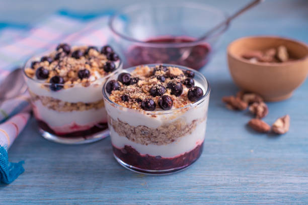 istock Delicious dessert - yogurt parfait with jam, nuts and currants in a glass 918016146