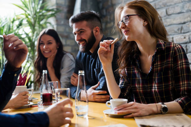 happy young friends hangout in coffee shop - friendship cafe social gathering talking imagens e fotografias de stock