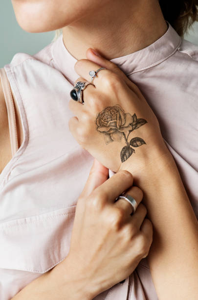 Closeup of hand tattoo of a woman Closeup of hand tattoo of a woman wrist tattoo stock pictures, royalty-free photos & images